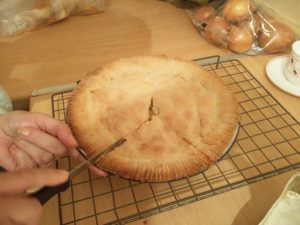 The tart being cut a second time