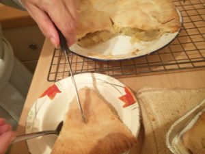 The tart being placed into a bowl