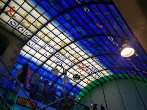 Inside a shopping arcade, looking at the stained glass ceiling