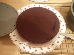 The base of the pan has been removed from the bottom of the cake