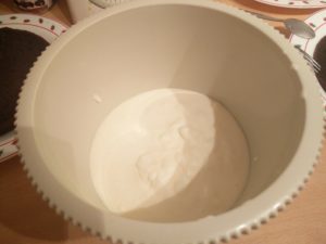 The electric mixer bowl with the mixture in