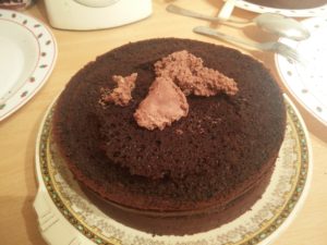 The third layer of cake with the whipping cream dollped onto it