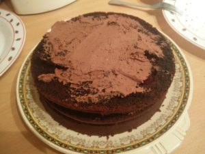 The third layer of the cake with the whipping cream spread out over the cake layer