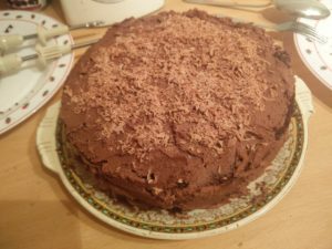 The final set of chocolate shavings on top of the cake