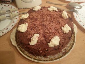 The cake with eight dollops of whipped cream on the top