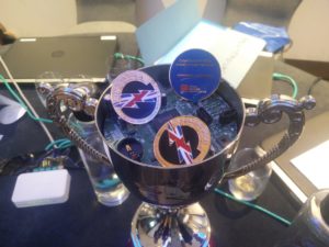The cup part of the trophy showing a circuit board and medals