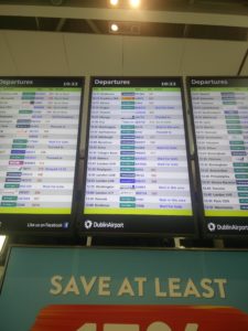 Departures boards at Dublin Airport showing the status of our next flight