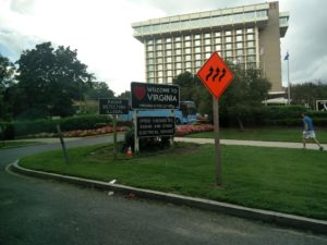 A sign saying "Welcome to Virginia", along with signs saying the vehicle speed is checked by Radar
