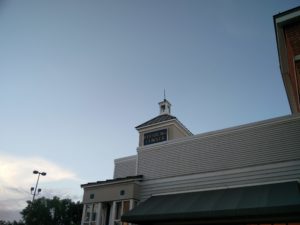 A Leesburg Corner sign on top of a shop