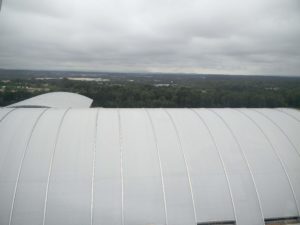 A westward looking photo showing the roof of the museum and mountains in the far distance