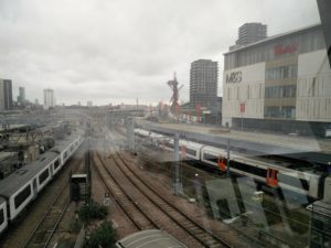 The Orbit sculpture, train tracks in the foreground, and The Shard in the far distance