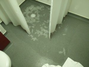 A puddle of water from the shower, showing the extent that it spread to